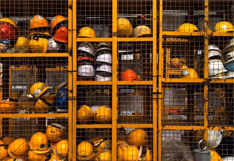 Safety helmets in a site safety cage