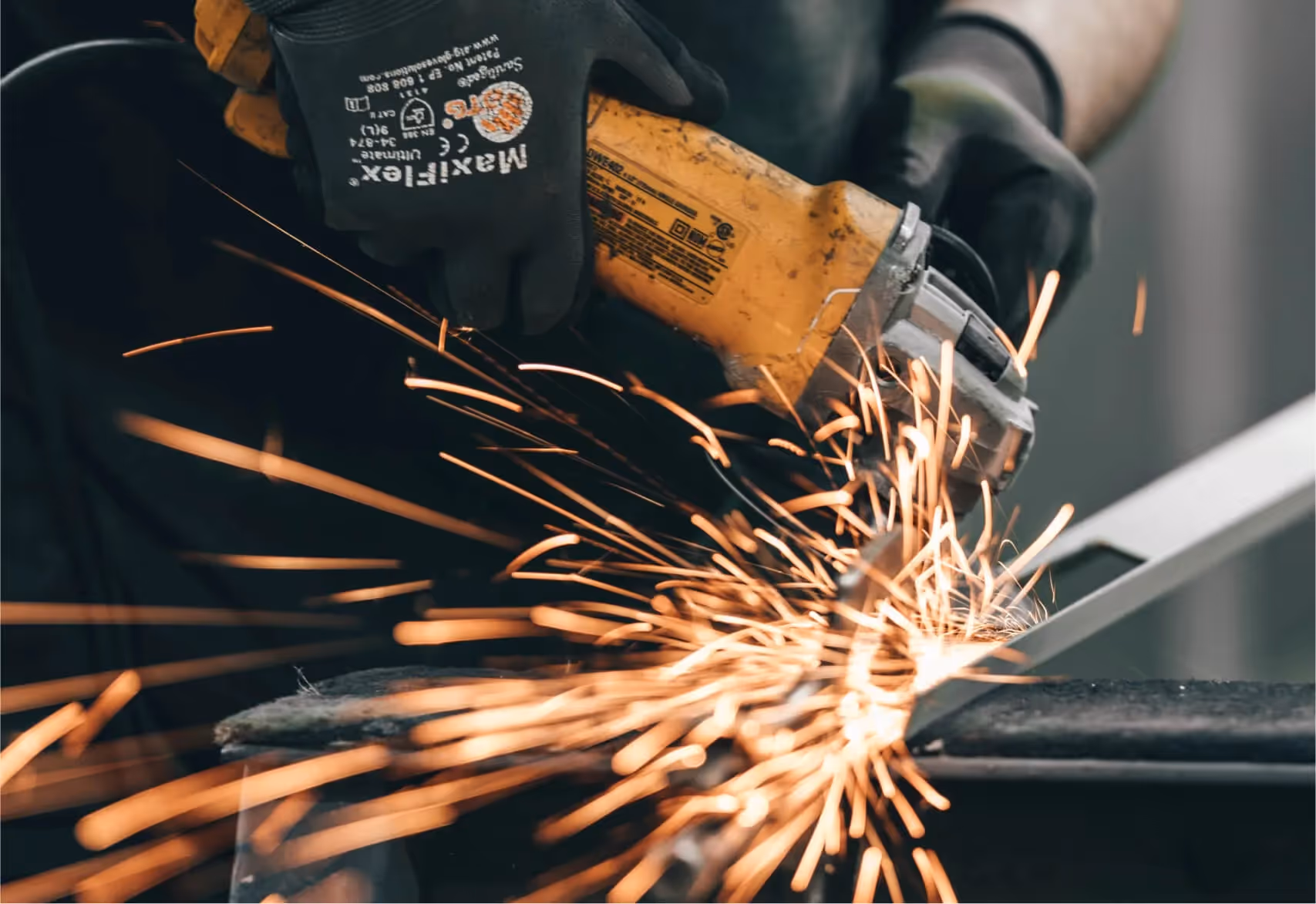 Man using an angle grinder with sparks flying